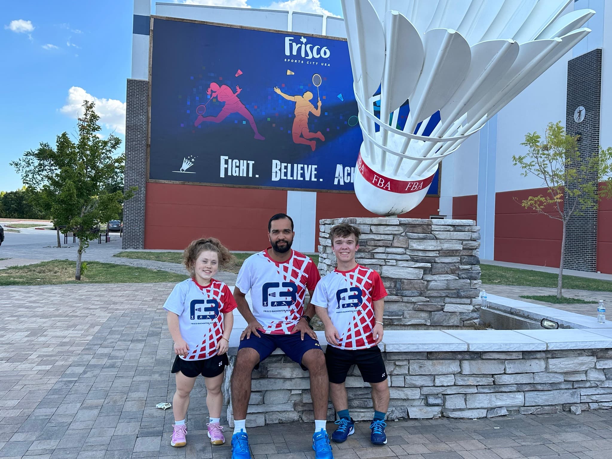 Coach Abhishek with Miles and Jayci outside Frisco Badminton Academy