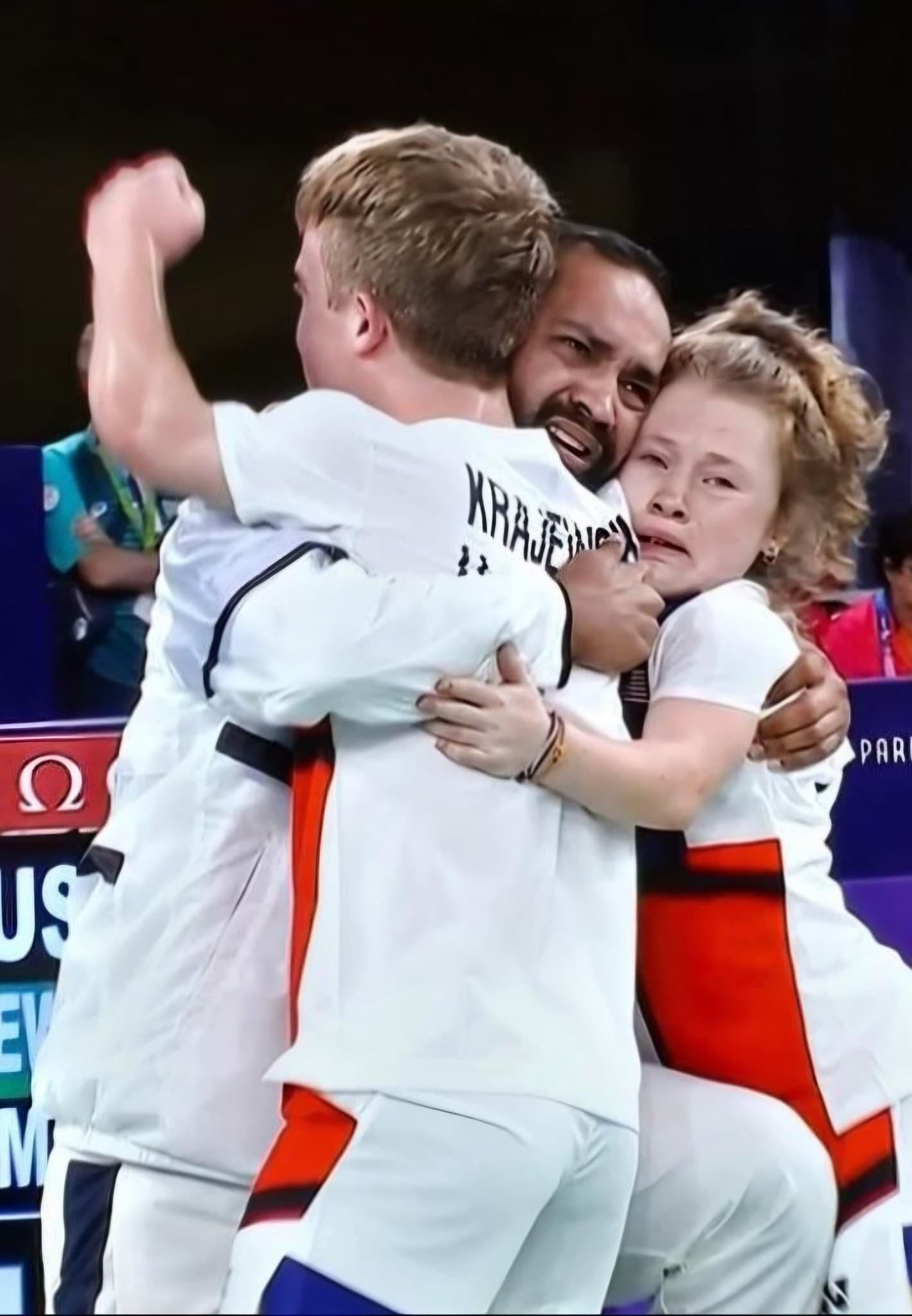 Miles and Jayci embracing Coach Abhishek courtside at Paris 2024