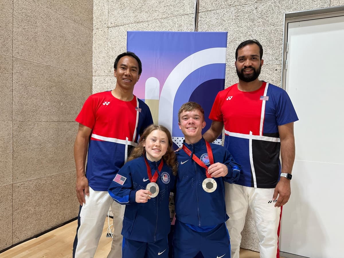 Miles, Jayci, and coaches posing with silver medals at Paris 2024