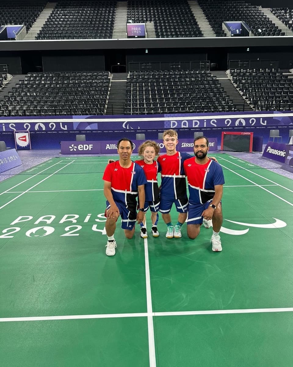The full team on the Paris 2024 badminton court